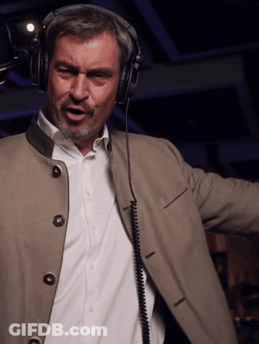 Man Wearing Headphones Singing Into Microphone GIF
