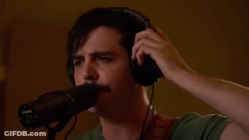 Man Wearing Headphones Singing Into Microphone GIF