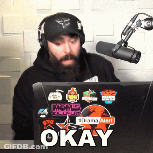 Man Wearing Headphones Sits In Front Of Laptop Saying Okay GIF