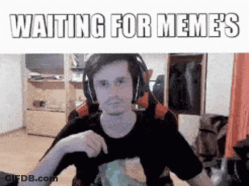 Man Wearing Headphones Sitting At Desk Waiting For Memes GIF