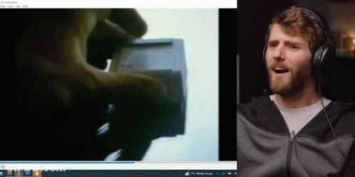Man Wearing Headphones Smiling Next To Computer GIF
