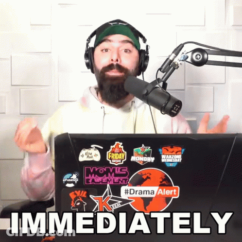 Man Wearing Headphones Stands In Front Of Laptop Immediately GIF