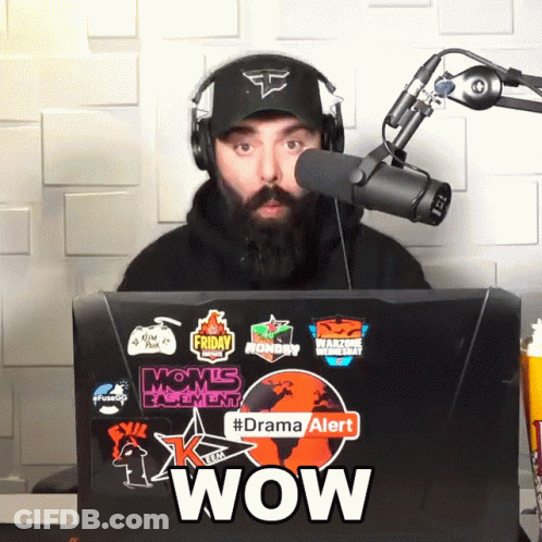 Man Wearing Headphones Stands In Front Of Laptop With Stickers Saying Wow GIF