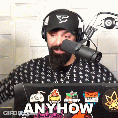 Man Wearing Headphones Stands In Front Of Microphone Laptop With Stickers Anyhow GIF