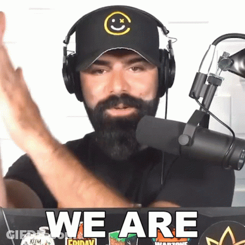 Man Wearing Headphones Stands In Front Of Microphone Says We Are GIF
