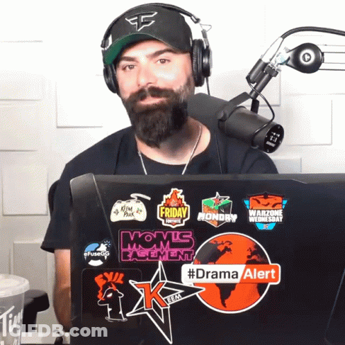 Man Wearing Headphones Stands In Front Of Microphone With #Dramaalert Sticker GIF