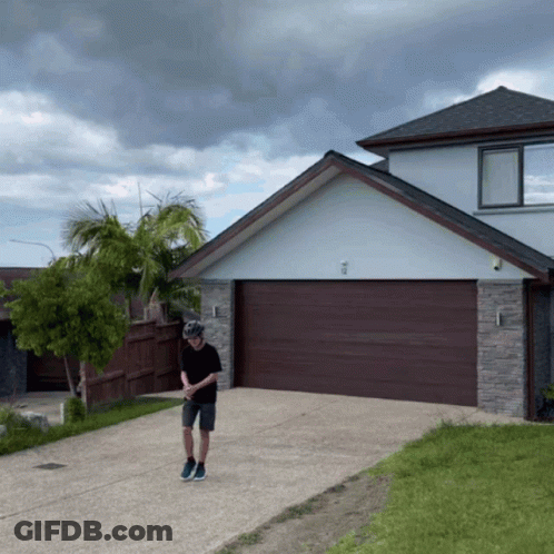 Man Wearing Helmet In Front Of House GIF