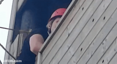 Man Wearing Helmet Looking Out Window GIF