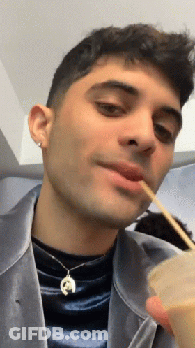 Man Wearing Horseshoe Necklace Eating With Chopsticks GIF