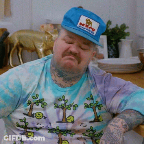 Man Wearing Kaboom Hat Sitting GIF