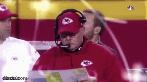 Man Wearing KS Hat And Headphones Holding Paper GIF