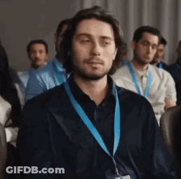 Man Wearing Lanyard Sitting In Room GIF