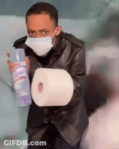 Man Wearing Mask Holding Toilet Paper And Spray GIF