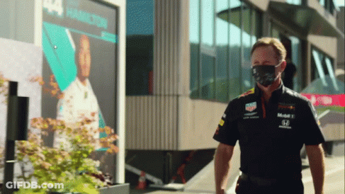 Man Wearing Mask In Front Of Hamilton Building GIF