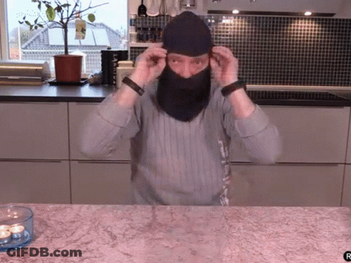 Man Wearing Mask Next To Candle GIF