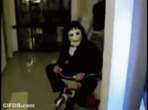 Man Wearing Mask Riding Bike GIF