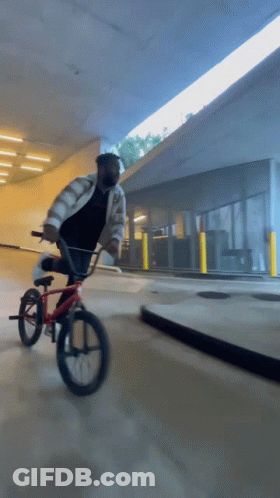 Man Wearing Mask Riding Red Bike GIF