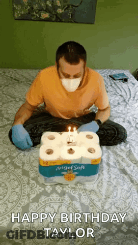 Man Wearing Mask Sitting With Toilet Paper Cake GIF