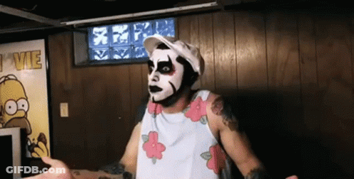 Man Wearing Mask Standing Before I VIE Sign GIF