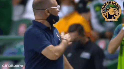 Man Wearing Mask Talking To Man With Puma Logo GIF