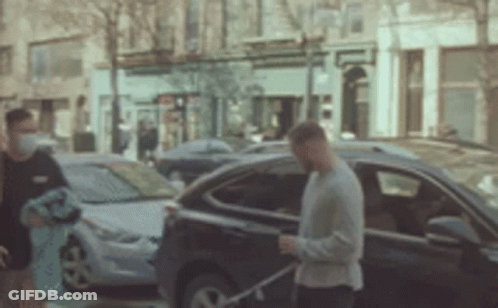 Man Wearing Mask Walking Towards Car GIF