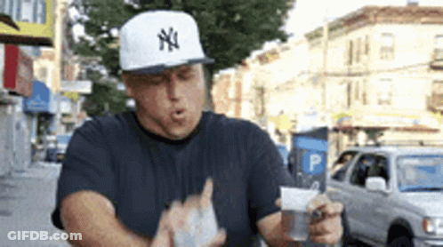 Man Wearing New York Yankees Hat Holding Bag Of Money GIF