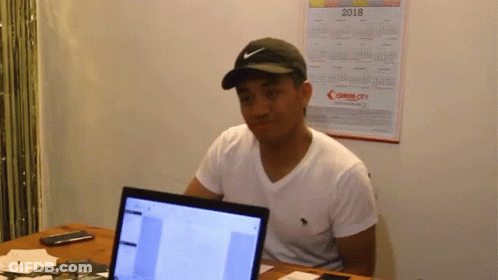 Man Wearing Nike Hat At Desk GIF