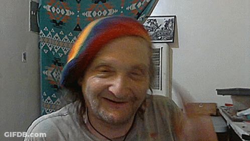 Man Wearing Rainbow Hat Smiling GIF