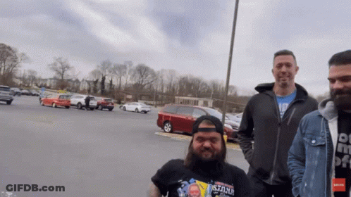 Man Wearing Stone Shirt In Parking Lot GIF