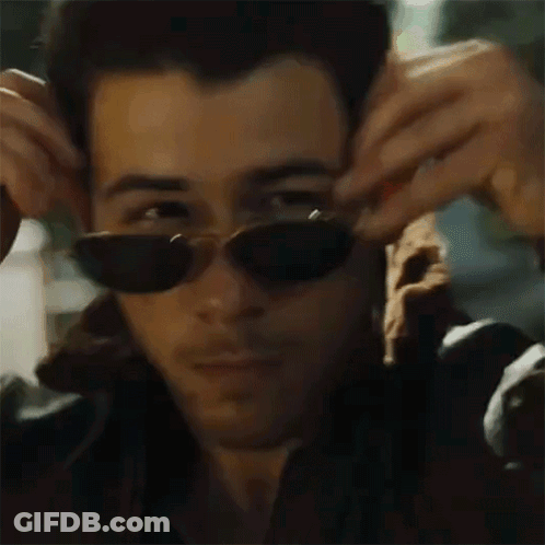 Man Wearing Sunglasses Adjusting Jacket GIF