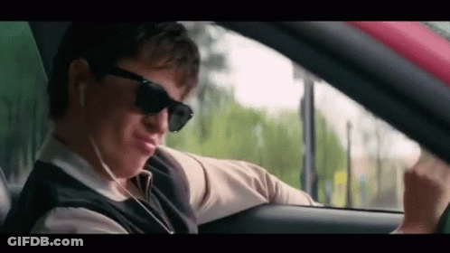 Man Wearing Sunglasses And Earphones Driving GIF