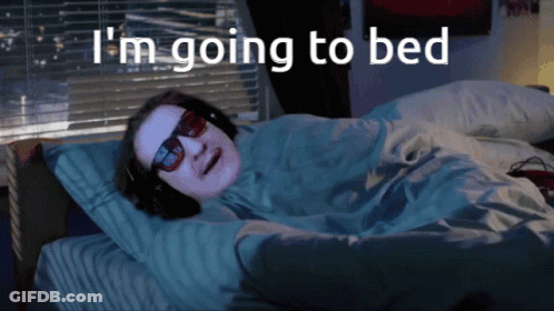 Man Wearing Sunglasses And Headphones Lying In Bed GIF