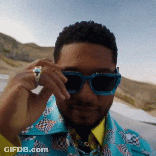 Man Wearing Sunglasses And Ring Looking At Camera GIF