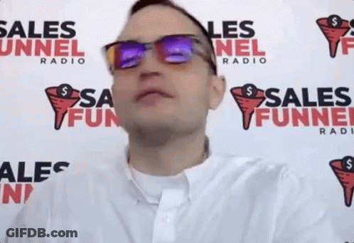 Man Wearing Sunglasses In Front Of Radio Sign GIF