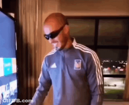 Man Wearing Sunglasses In Front Of TV GIF
