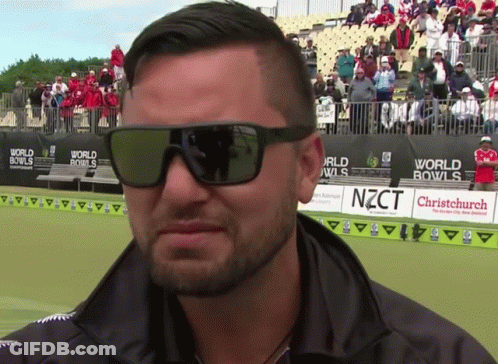Man Wearing Sunglasses In Front Of World Bowls Sign GIF