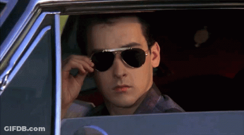 Man Wearing Sunglasses Looking Out Car Window GIF