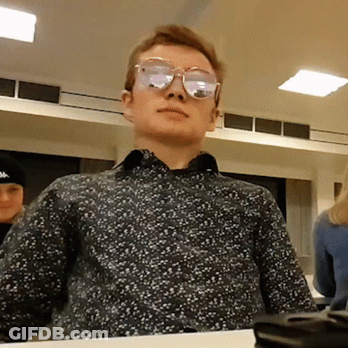 Man Wearing Sunglasses Sitting At Table GIF