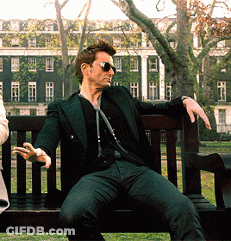 Man Wearing Sunglasses Sitting On Park Bench GIF
