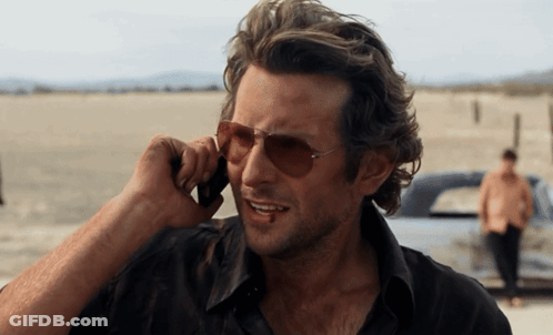 Man Wearing Sunglasses Talking On Phone GIF