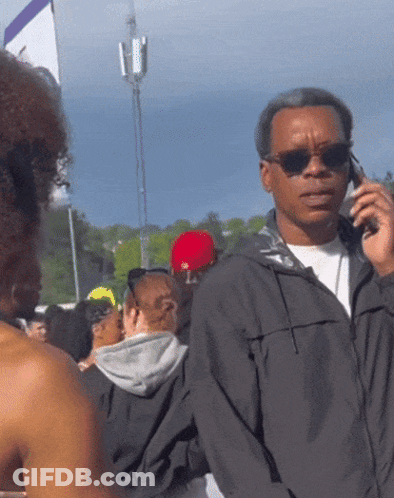 Man Wearing Sunglasses Talking On Phone GIF