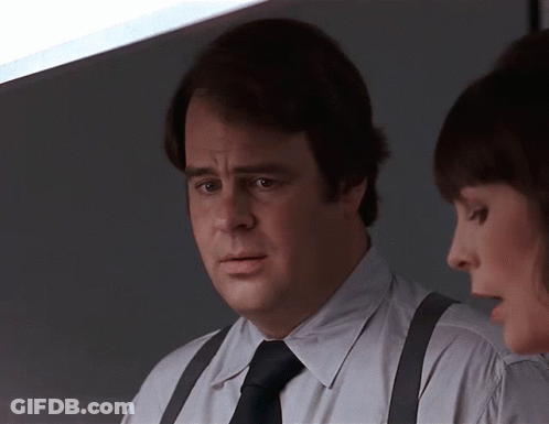 Man Wearing Suspenders And Tie Talks To Another Man GIF