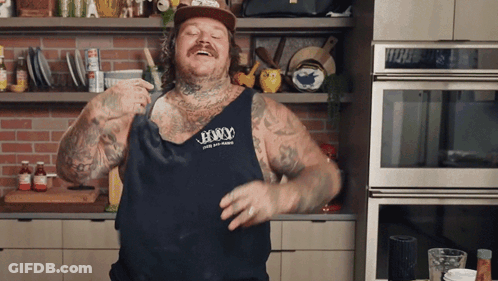 Man Wearing Tank Top That Says Legacy Dancing In Kitchen GIF
