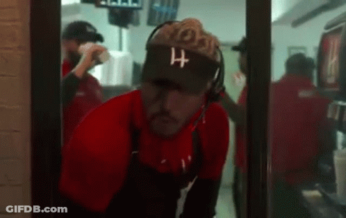 Man Wearing Visor And Headphones In Restaurant Doorway GIF
