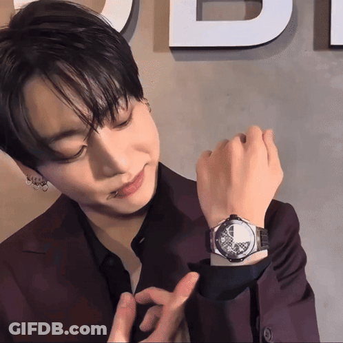 Man Wearing Watch In Front Of Di Sign GIF