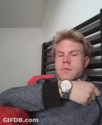 Man Wearing Watch Sitting In Bed GIF