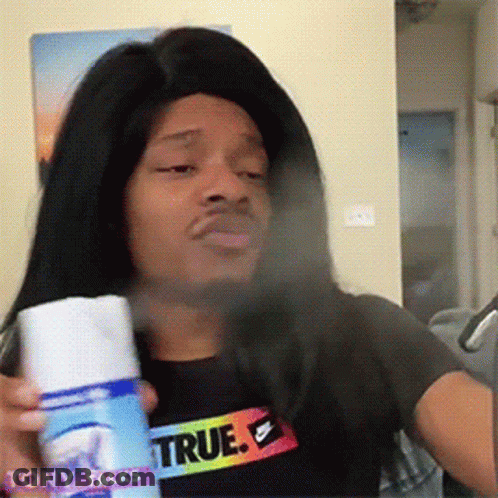 Man Wearing Wig And True Shirt Spraying Face GIF