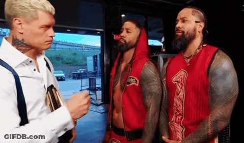 Man White Shirt Talking Two Red Shirts 1 GIF