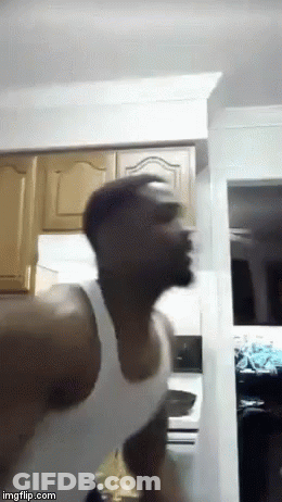 Man White Tank Top Standing Head Down Kitchen GIF
