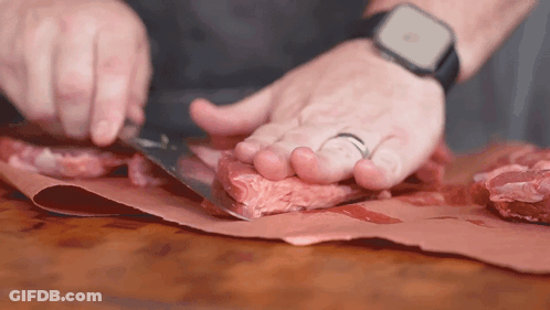 Man With Apple Watch Cutting Meat GIF